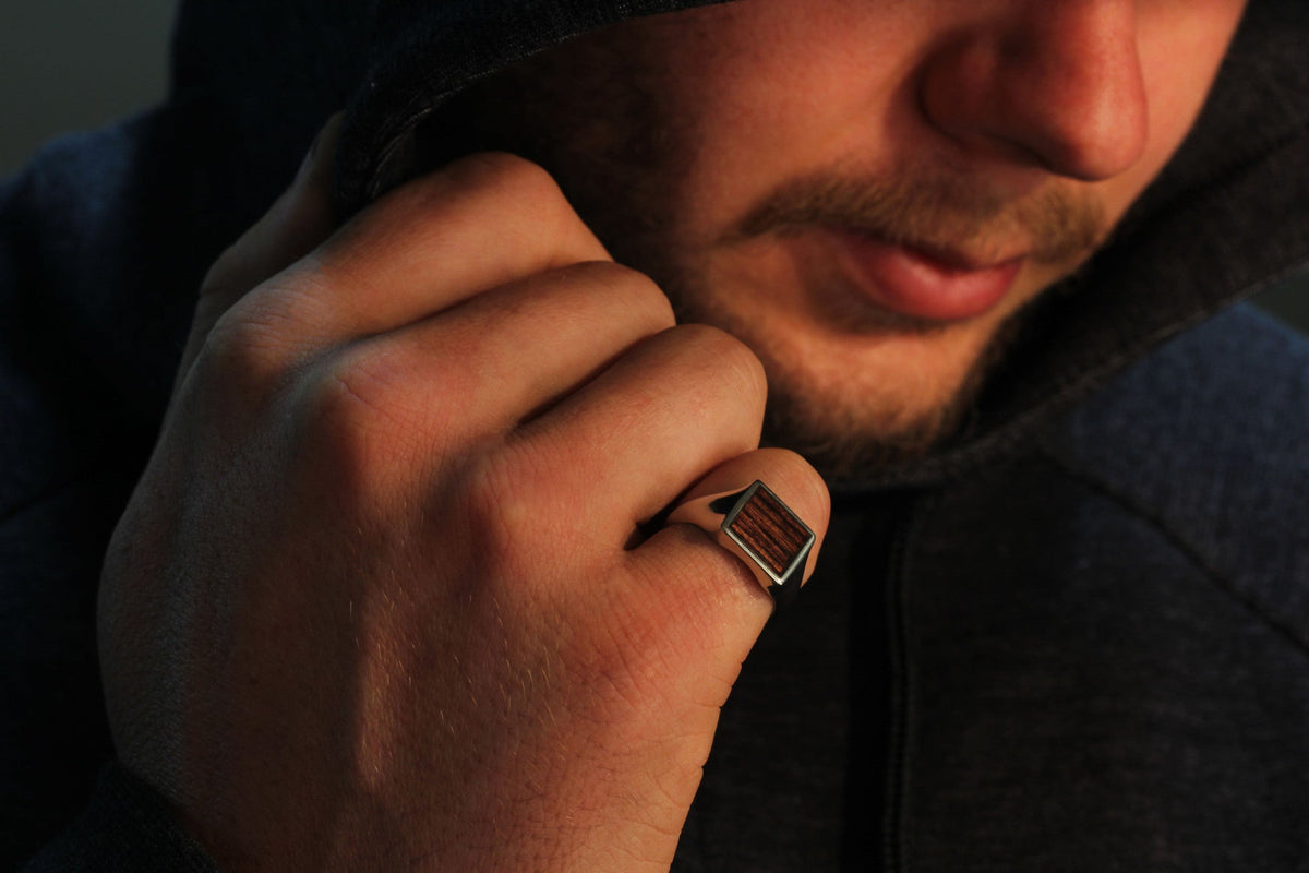 man with silver wood ring
