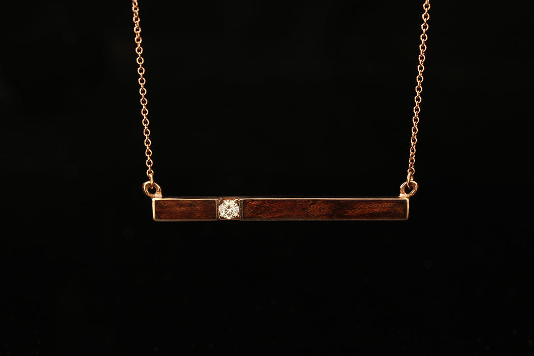 Horizontal Gold bar pendant with bubinga waterfall wood inlay and diamond setting, Chasing Victory, dark wood, gold chain