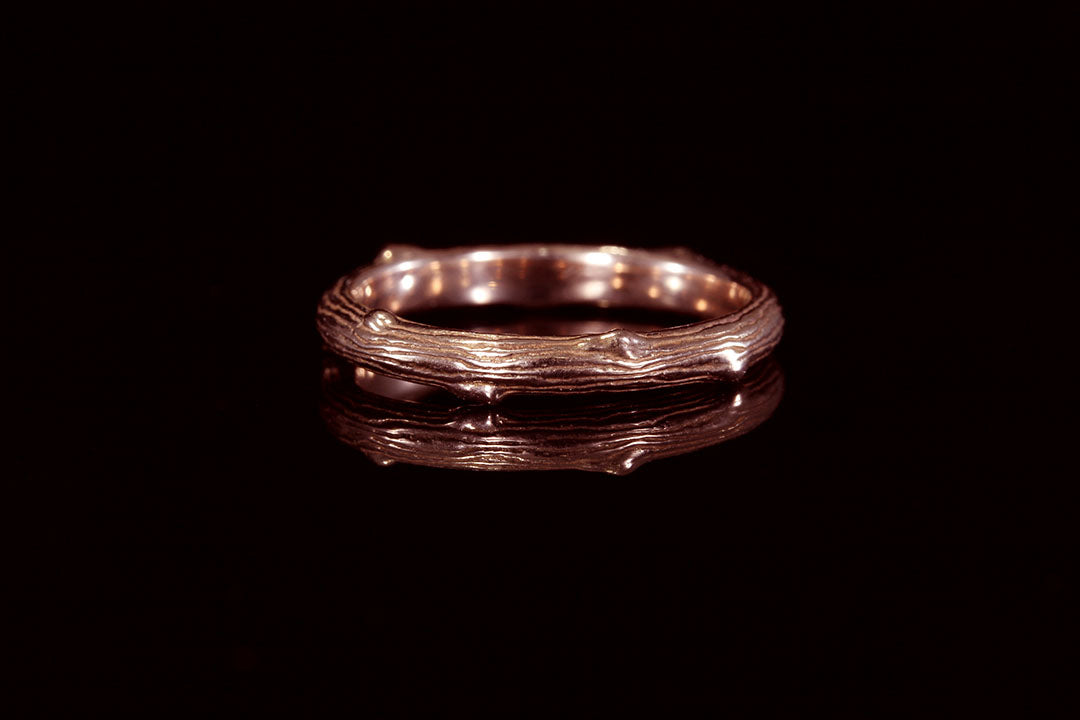 Rose gold twig ring with black background, Chasing Victory, rose gold interior band