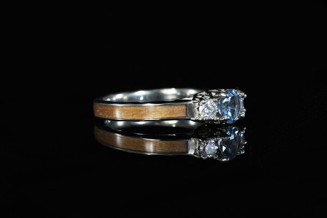 3 stone "Coral of the Sea" engagement ring, side view, silver and wooden band, Chasing Victory