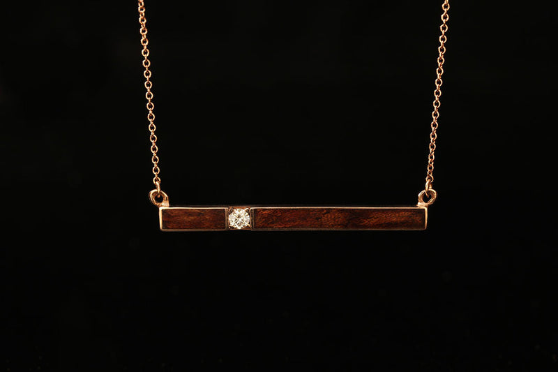 Horizontal Gold bar pendant with bubinga waterfall wood inlay and diamond setting, Chasing Victory, dark wood, gold chain