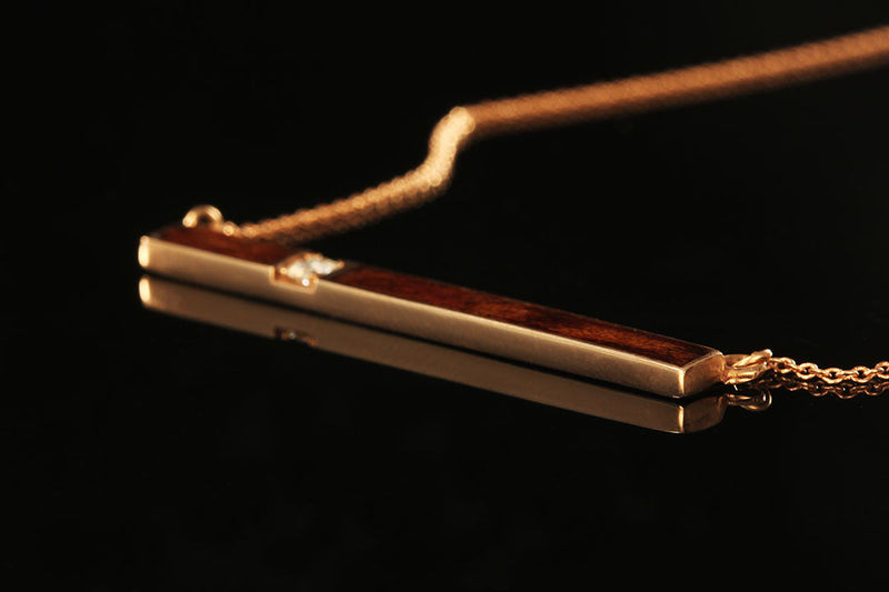 Gold Pendant with Wood and Diamond Inlay, Chasing Victory