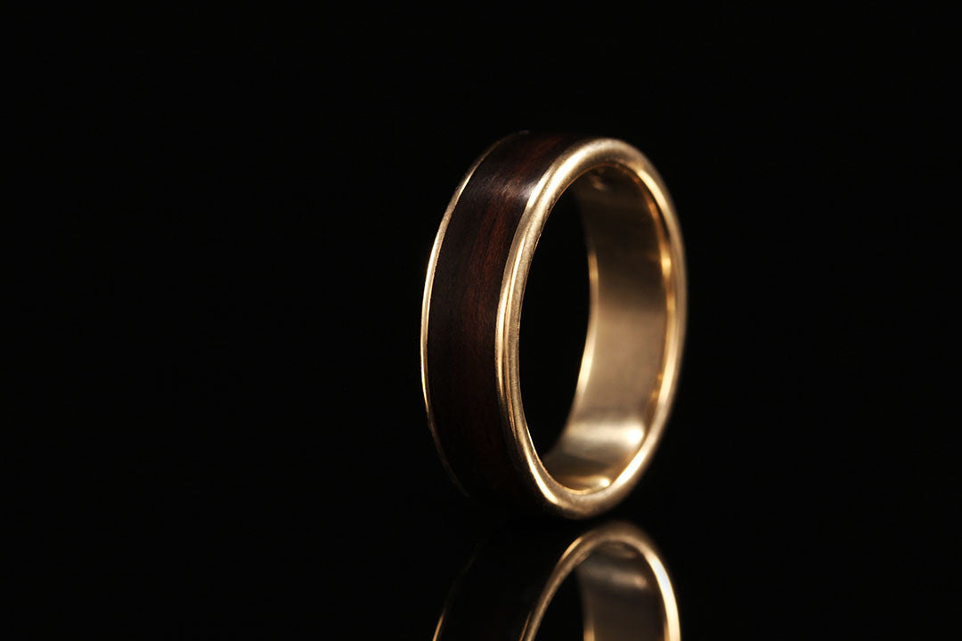 Mens wedding wood ring, upright view, golden interior band, ebony wood exterior